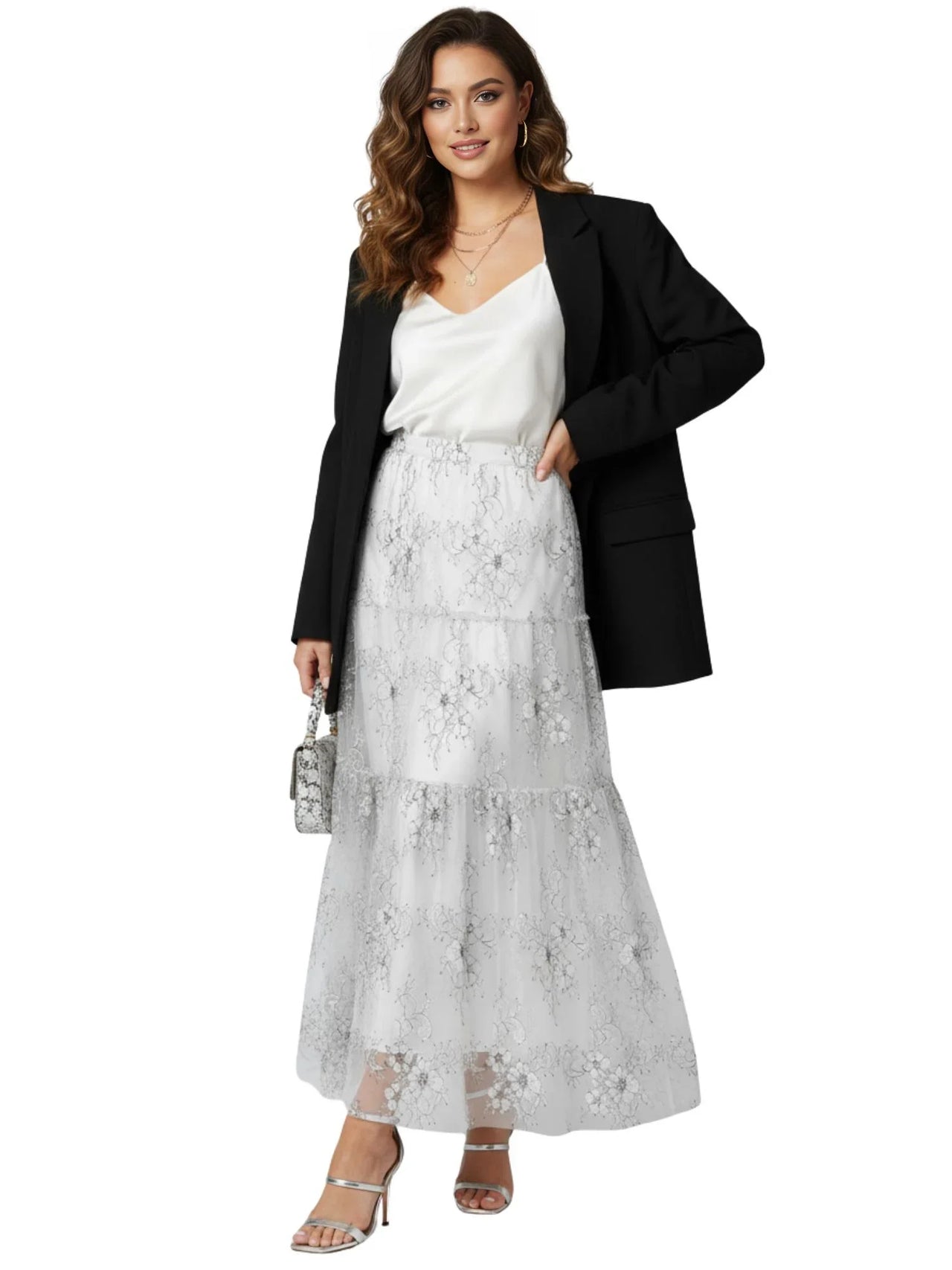 Woman wearing a white lace skirt with a black blazer on a white background