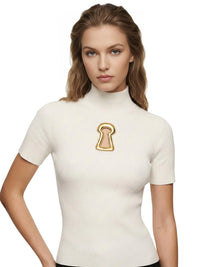 Thumbnail for Woman wearing a white turtleneck top with a gold keyhole cutout on a white background