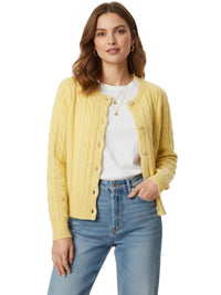 Thumbnail for Woman wearing a yellow cardigan over a white shirt and blue jeans on a white background