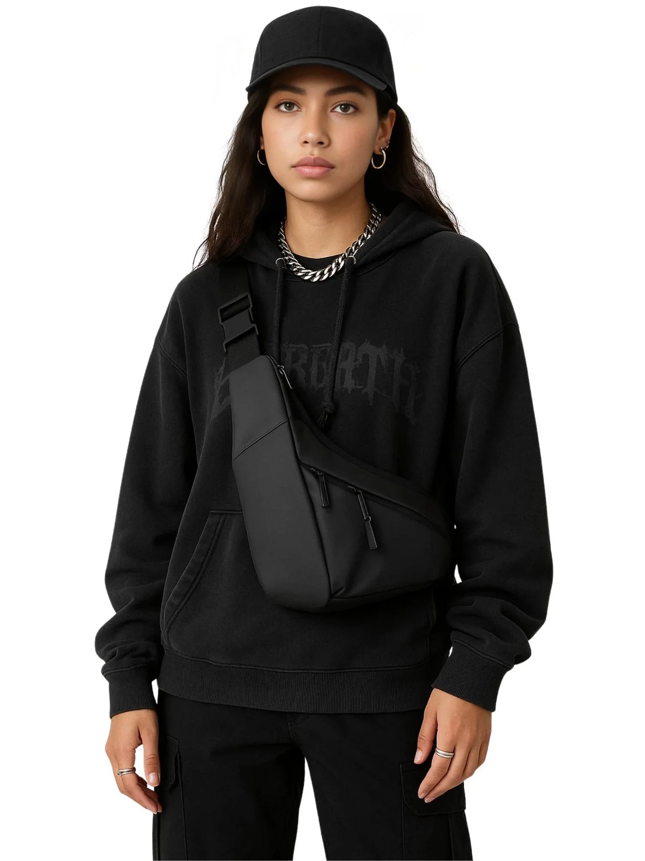 Woman wearing a black hoodie and pants with a black crossbody bag on a white background