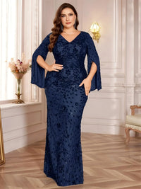 Thumbnail for Plus size woman wearing a navy blue mermaid dress in an elegant room.