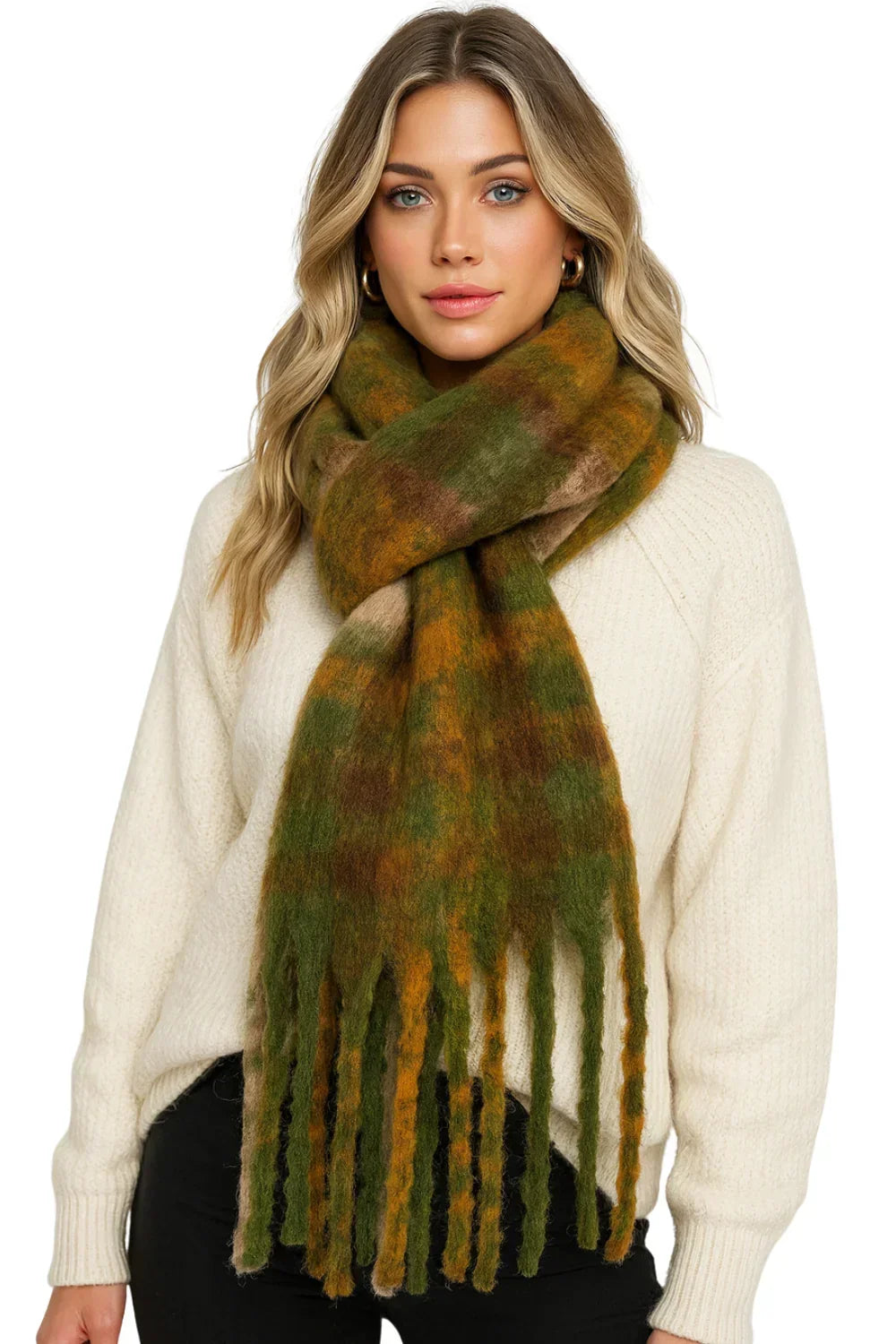 Woman wearing a green and brown plaid scarf with a white sweater on a white background