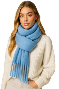 Thumbnail for Woman wearing a light blue scarf and white sweater on a white background