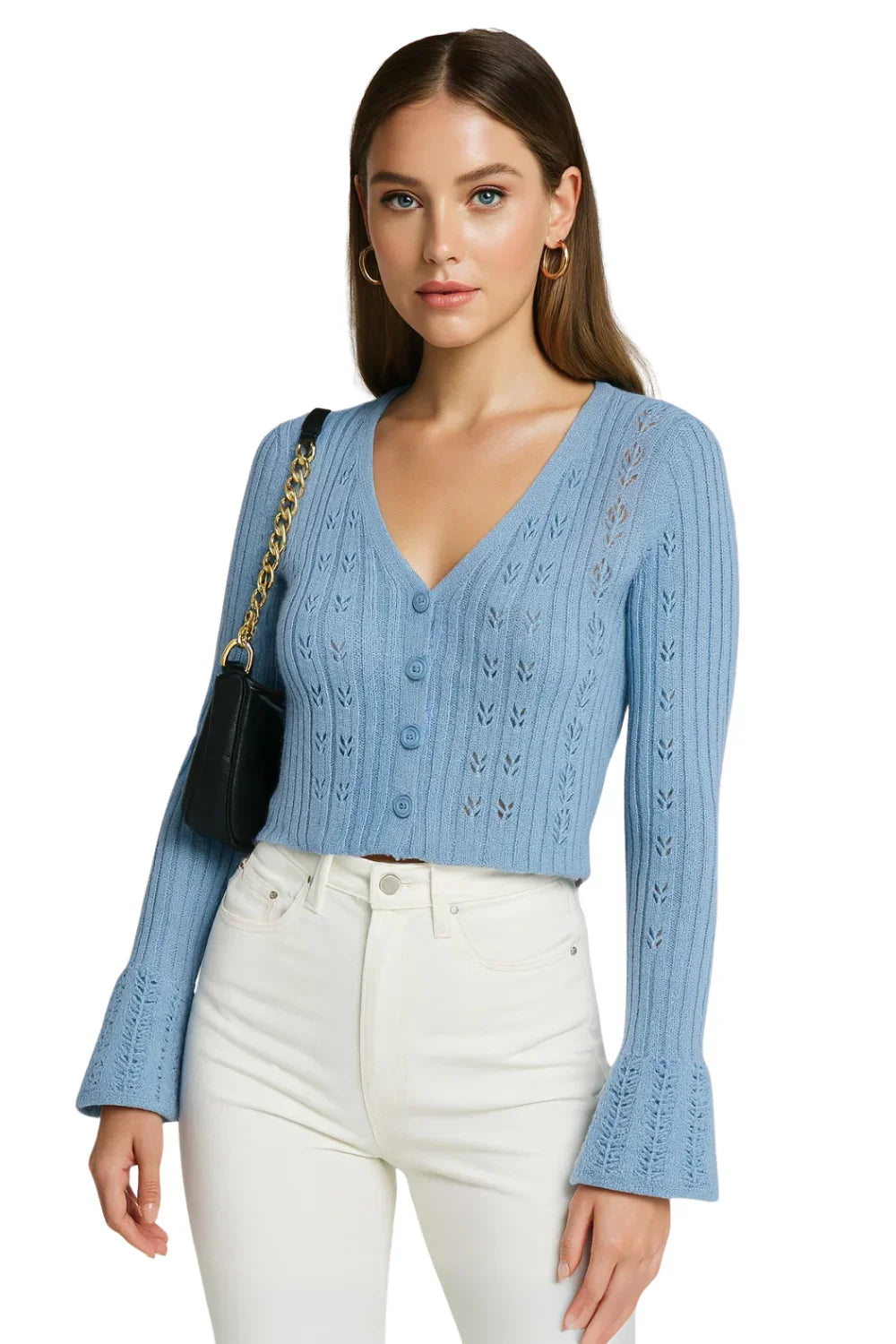 Woman wearing a blue cropped cardigan sweater and white pants on a white background