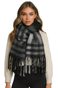 Thumbnail for Woman wearing a black and gray plaid scarf with fringe on a white background