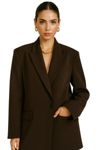 Thumbnail for Woman wearing a brown blazer on a white background