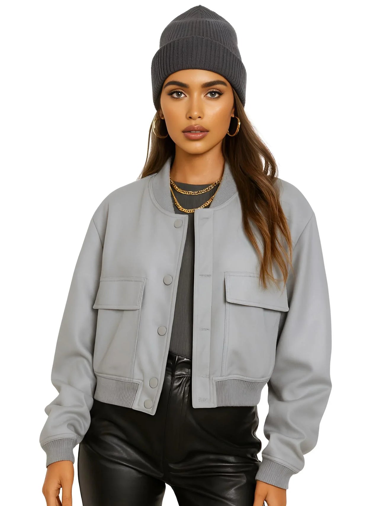 Woman wearing a gray jacket, black pants, and a gray beanie on a white background