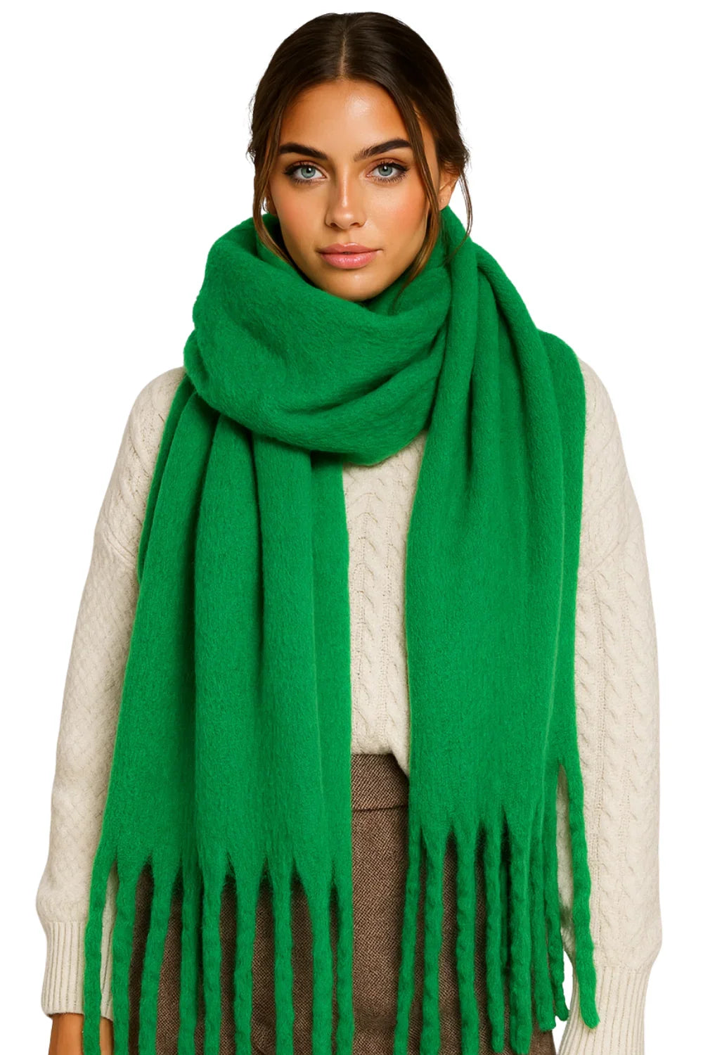 Woman wearing a green blanket scarf with a white sweater on a white background