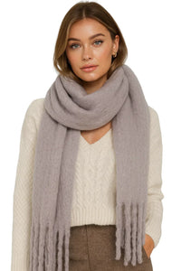 Thumbnail for Woman wearing a large light gray blanket scarf with a white sweater and brown pants on a white background