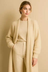 Thumbnail for Woman wearing a long fluffy khaki cardigan over a matching outfit against a beige background