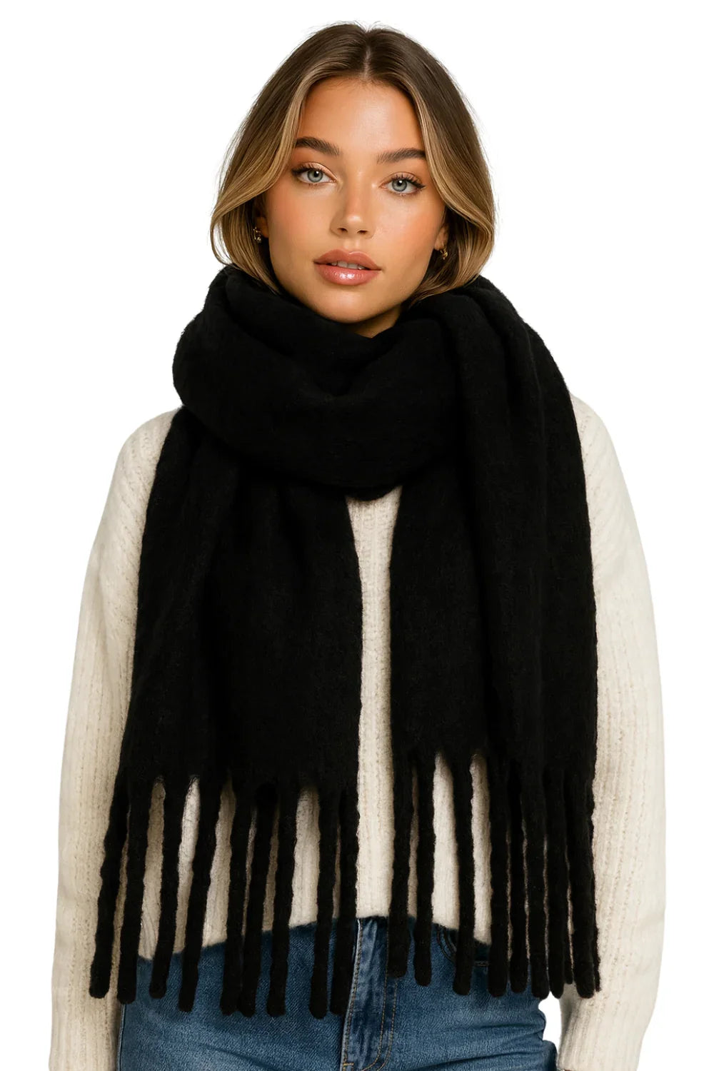 Woman wearing a black blanket scarf with fringe on a white background