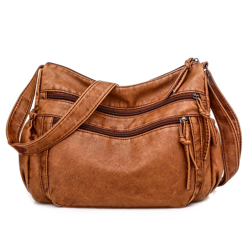Fashionable, timeless, and versatile, this chic leather messenger bag is a must-have for the stylish professional woman. Crafted from high-quality vegan leather