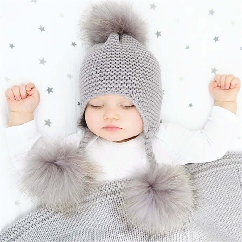 Shop Now & Get Free Shipping + We'll Pay The Tax! Baby hat features three removeable 100% real fur pompoms. Perfect for keeping your little one warm this winter